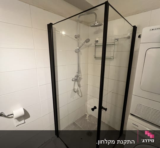 מקלחון זכוכית עם ראש מקלחת מתכתי ומדף קטן